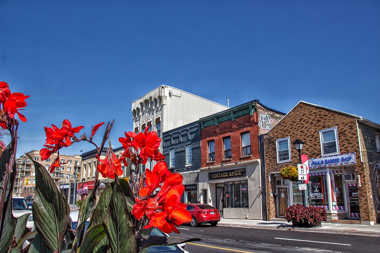 Flower-lined heritage storefronts along Yonge Street in downtown Aurora, Ontario